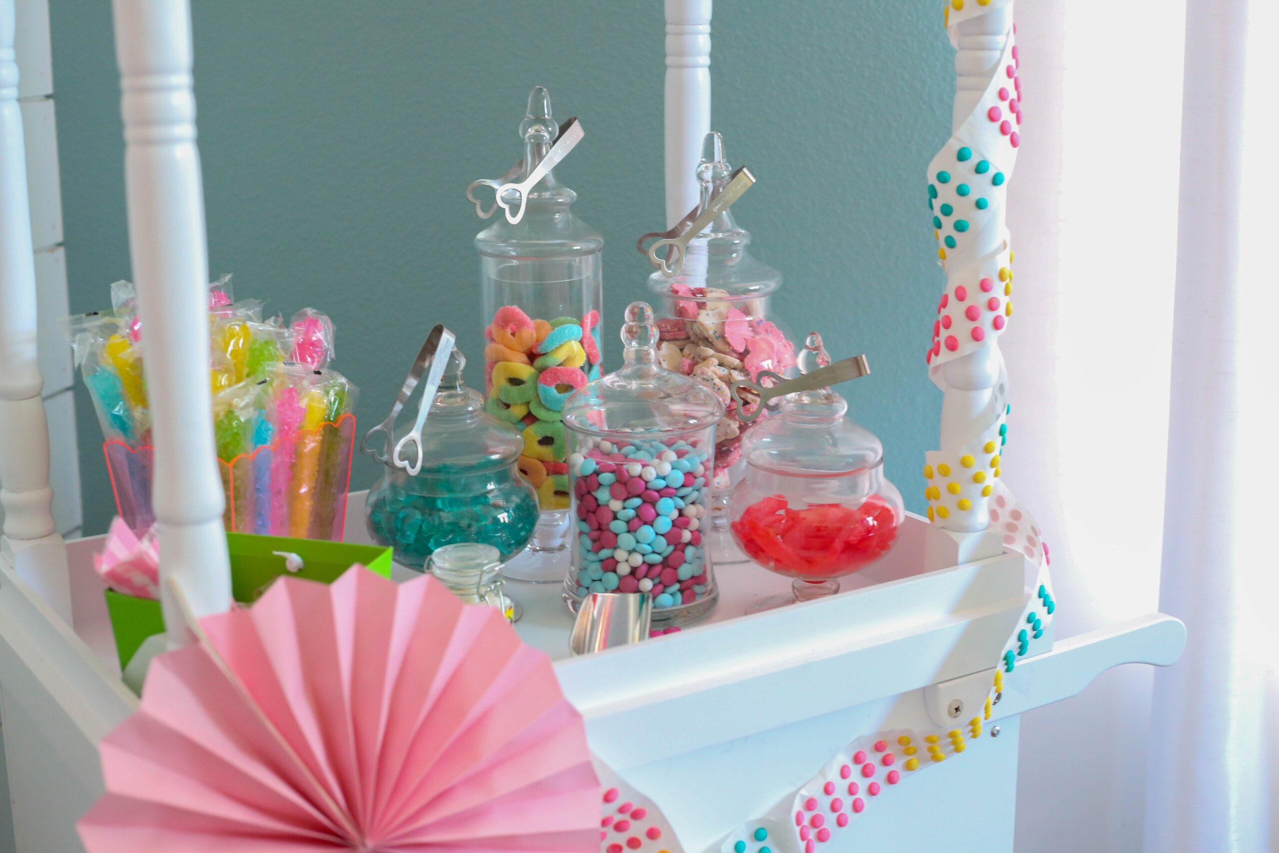 candy cart with candy jars filled with colorful candy