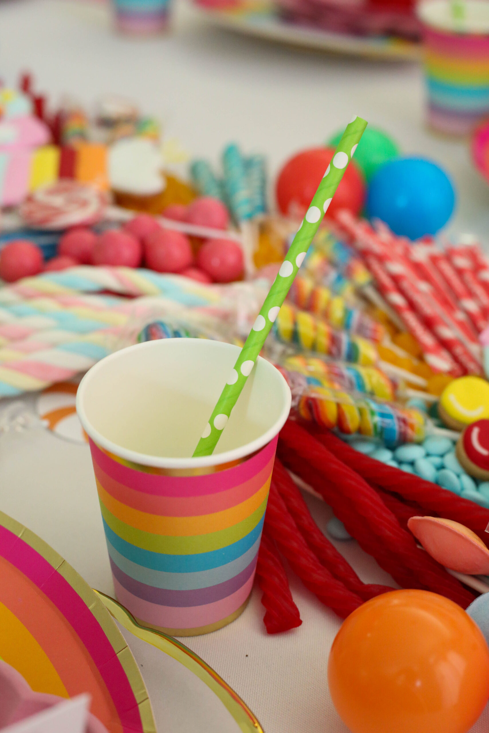 rainbow party cups with lime green polka dot straws 