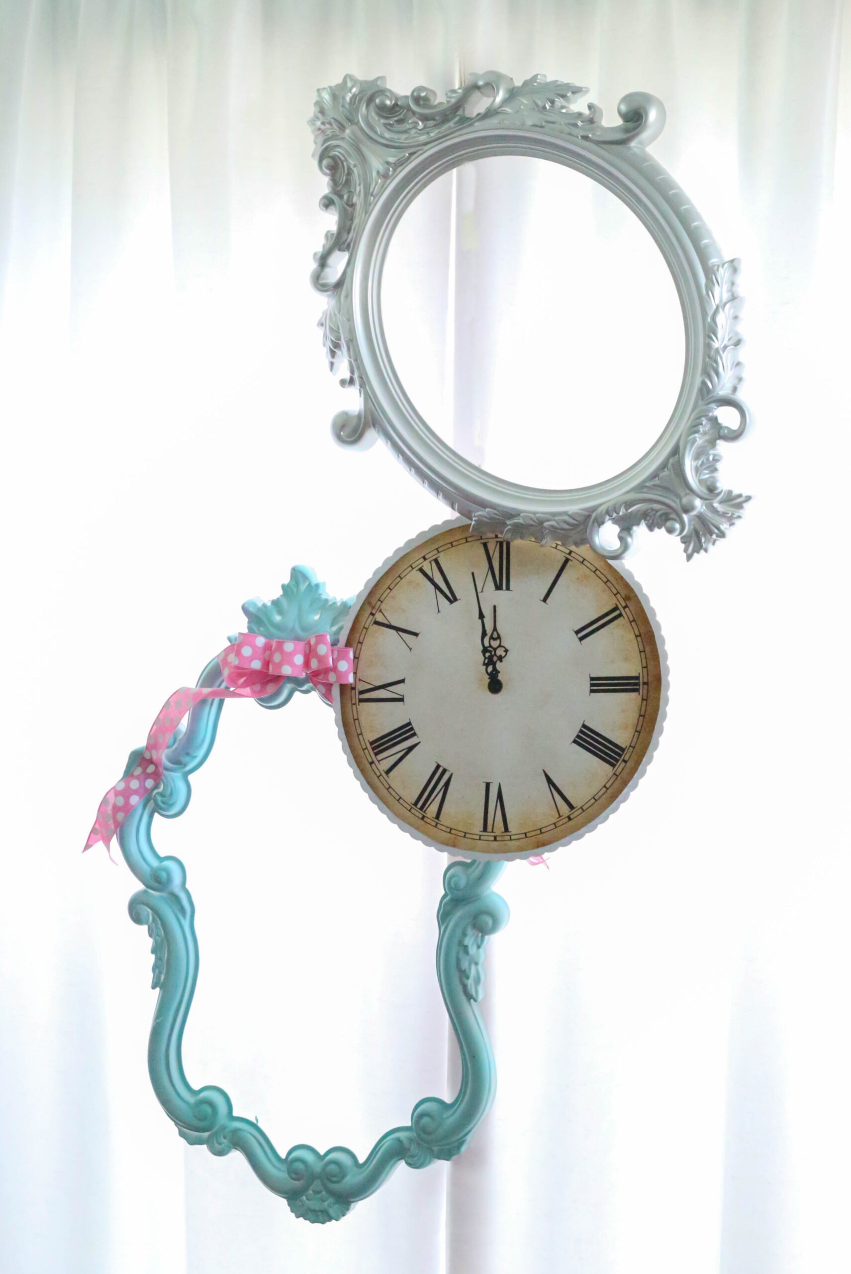 ornate painted frames and clock hung 