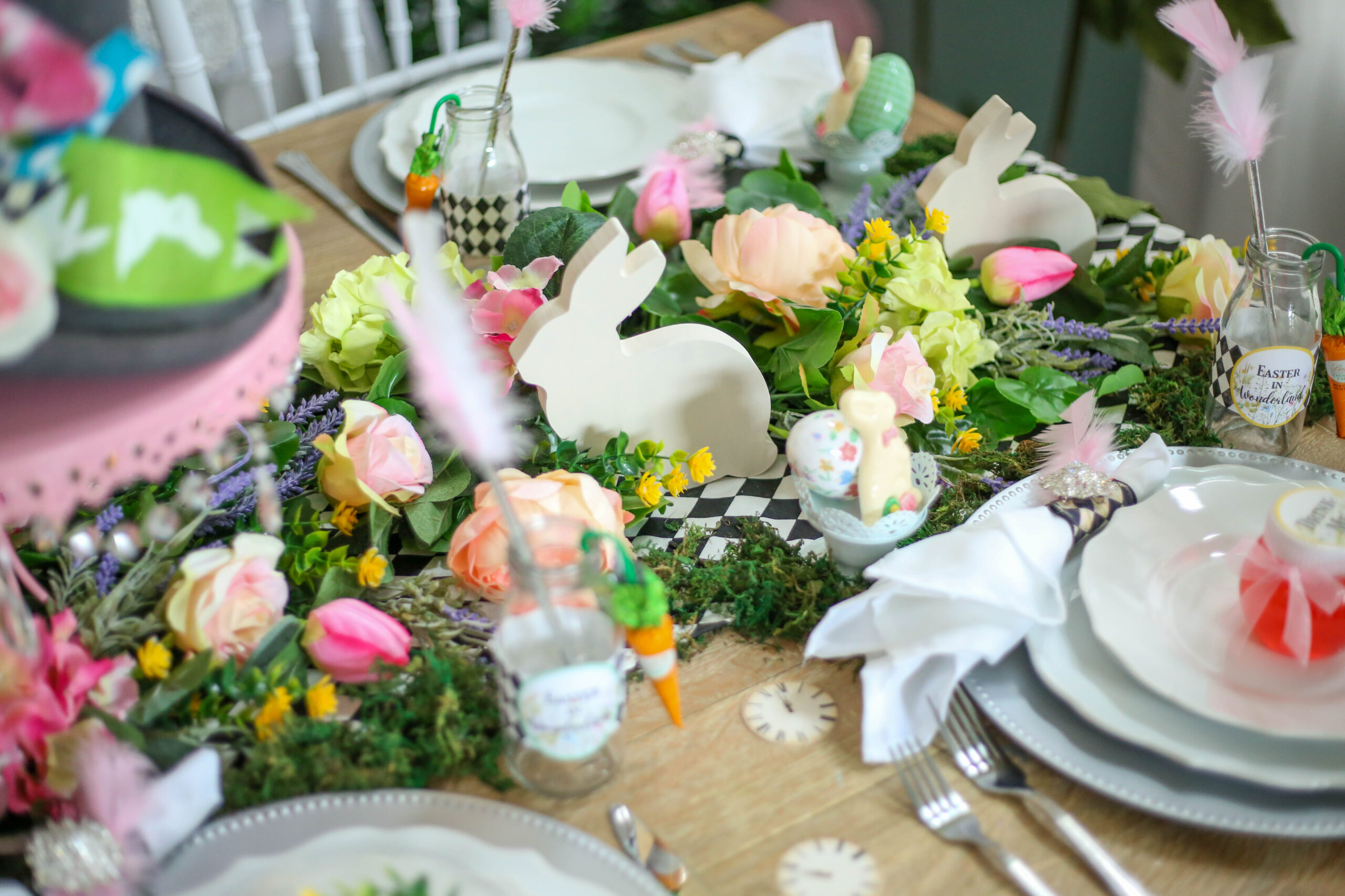 wood cut bunnies in a floral tablescape for easter