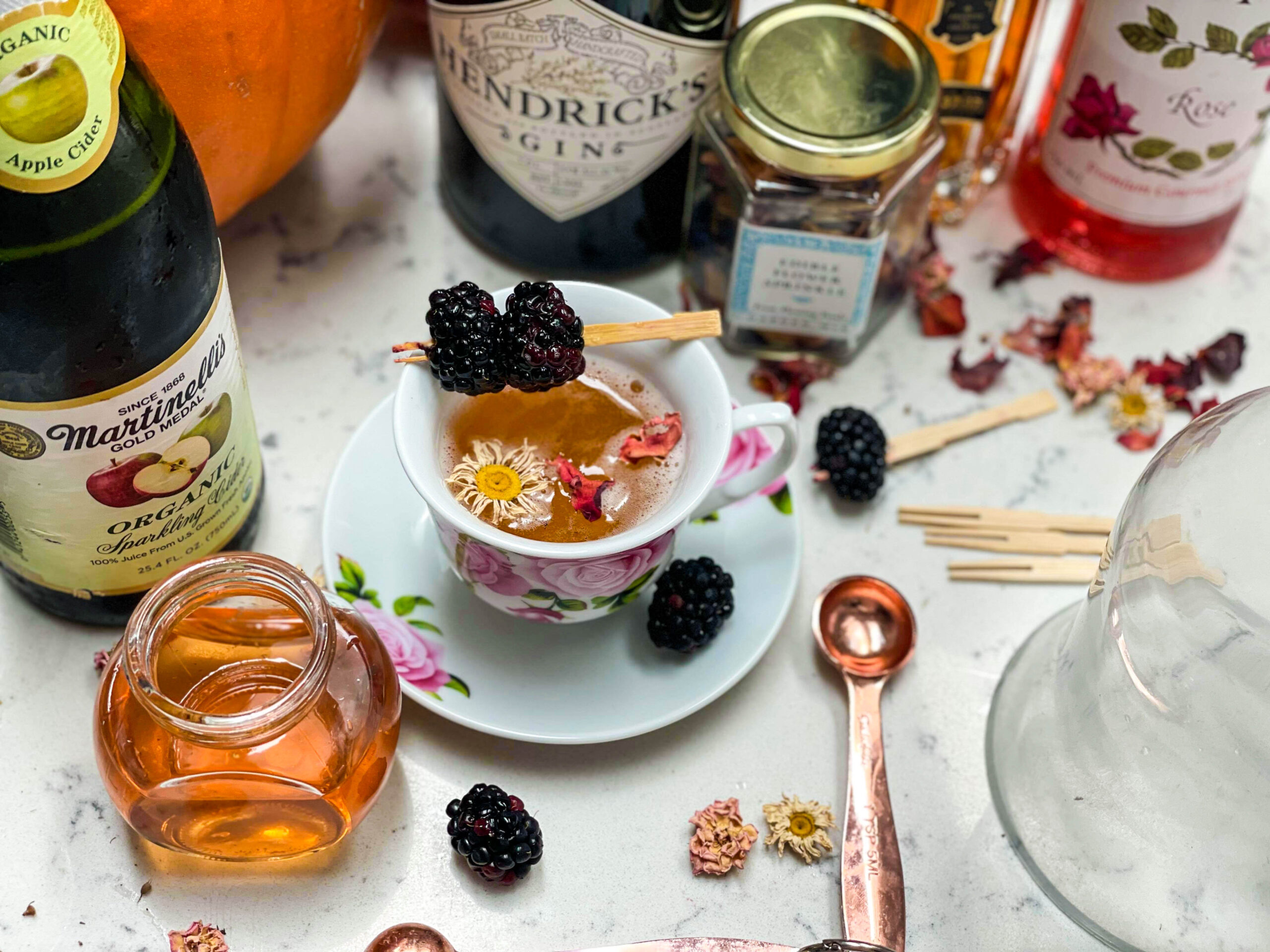 smoked tea cider cocktail with edible flowers