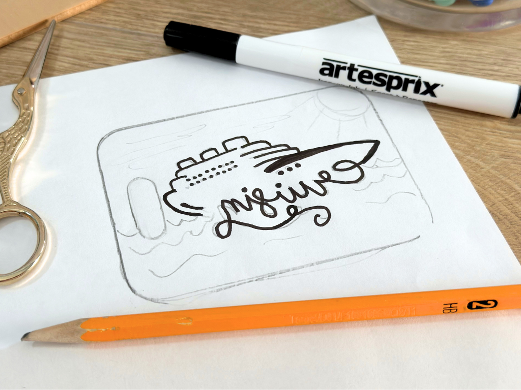 Using a black sharpie to trace a hand drawn sublimation design which will be transferred to an Artesprix sublimation luggage tag